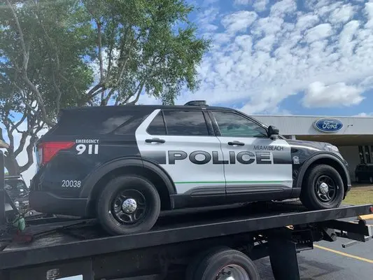 Miami Beach Police vehicle being towed by AC Towing