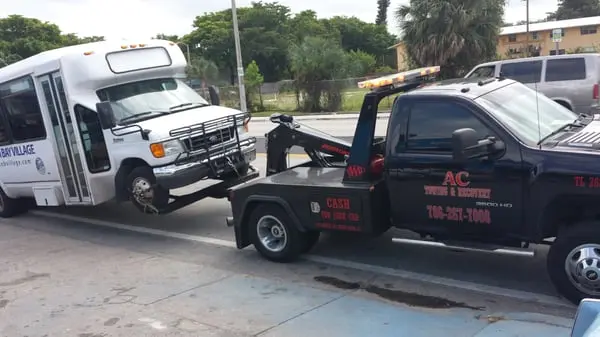 AC Towing & Recovery towing a shuttle bus