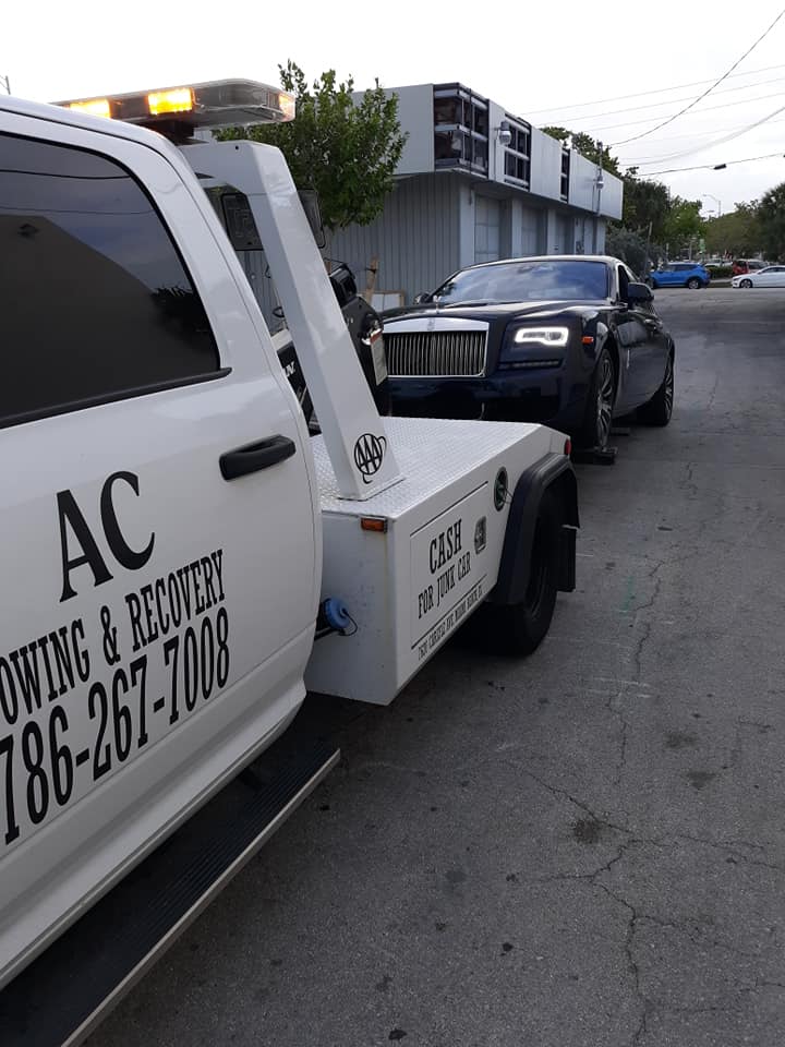 AC Towing & Recovery truck towing a Rolls-Royce in Miami
