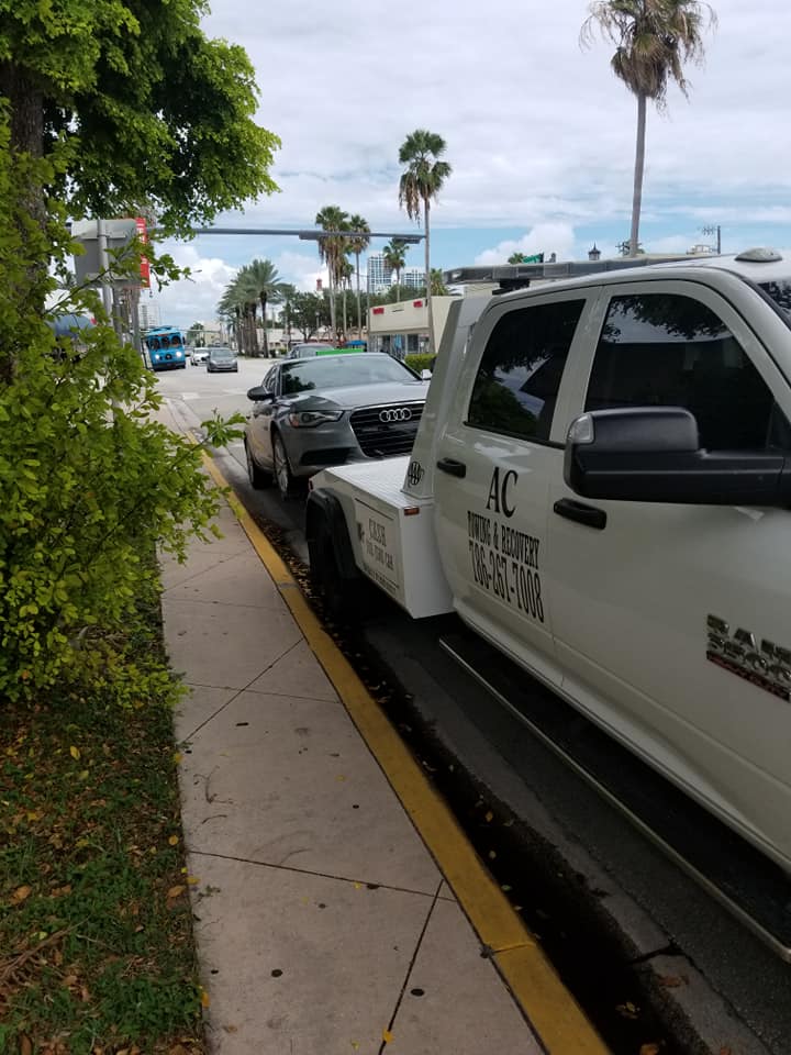 AC Towing truck on Miami Beach with palm trees